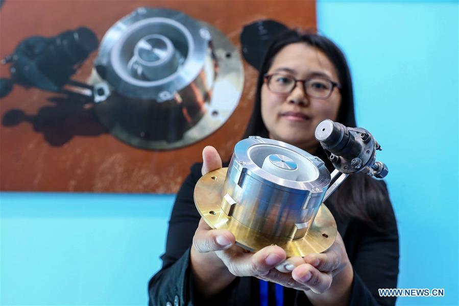 A staff member shows an electric thruster used on satellites during a press preview of the 2018 National Mass Innovation and Entrepreneurship Week in Beijing, capital of China, Oct. 8, 2018. The weekly event will run from October 9 to 15. (Xinhua/Zhang Yuwei)
